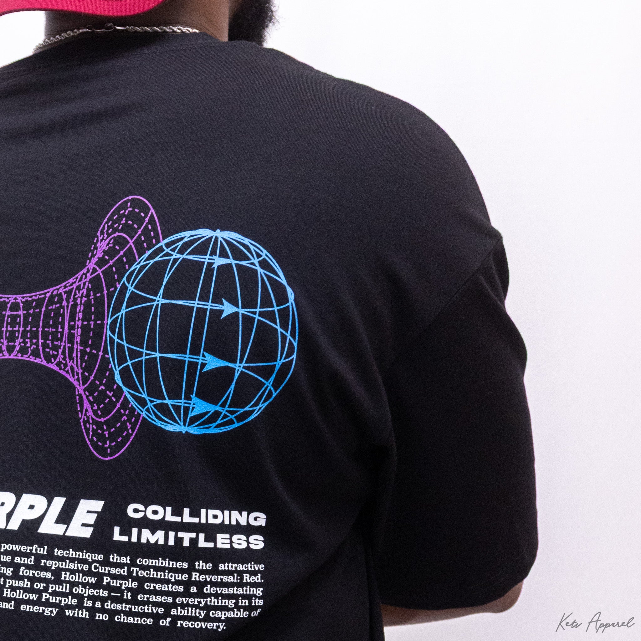 Black t-shirt with a graphic design and text on the back, worn by a person.