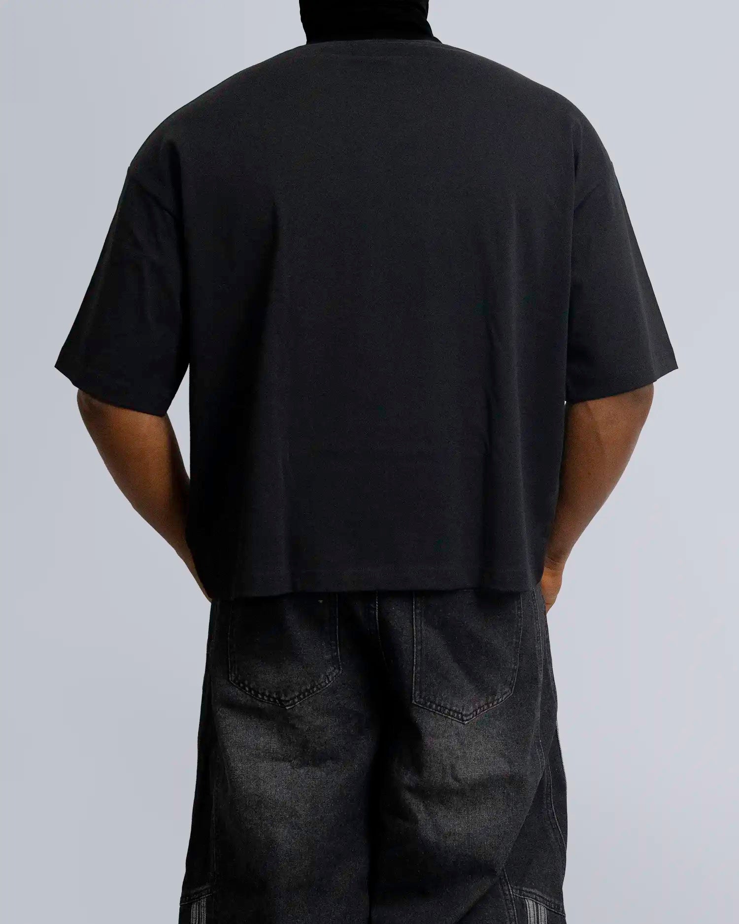 Person wearing a black t-shirt and pants on a gray background option1_black