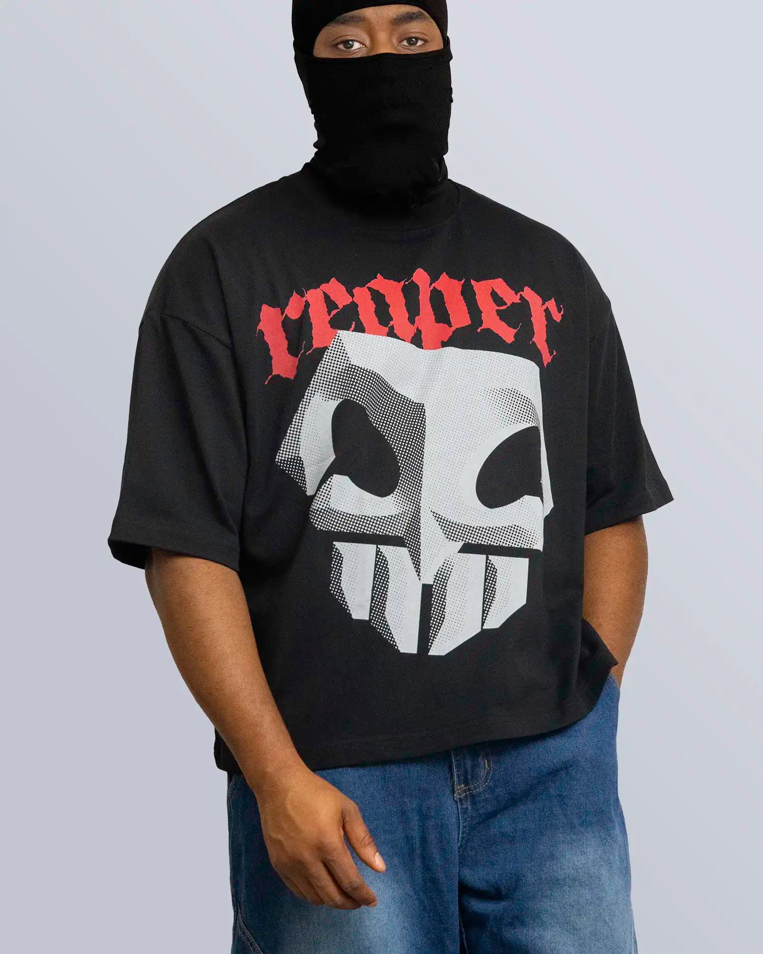 Person wearing a black t-shirt with a skull design and 'reaper' text, standing against a plain background. option1_black