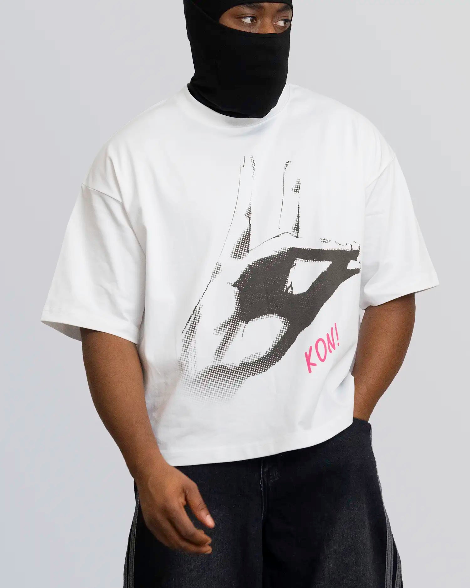 Person wearing a white t-shirt with a graphic design and text, standing against a plain background. option1_white