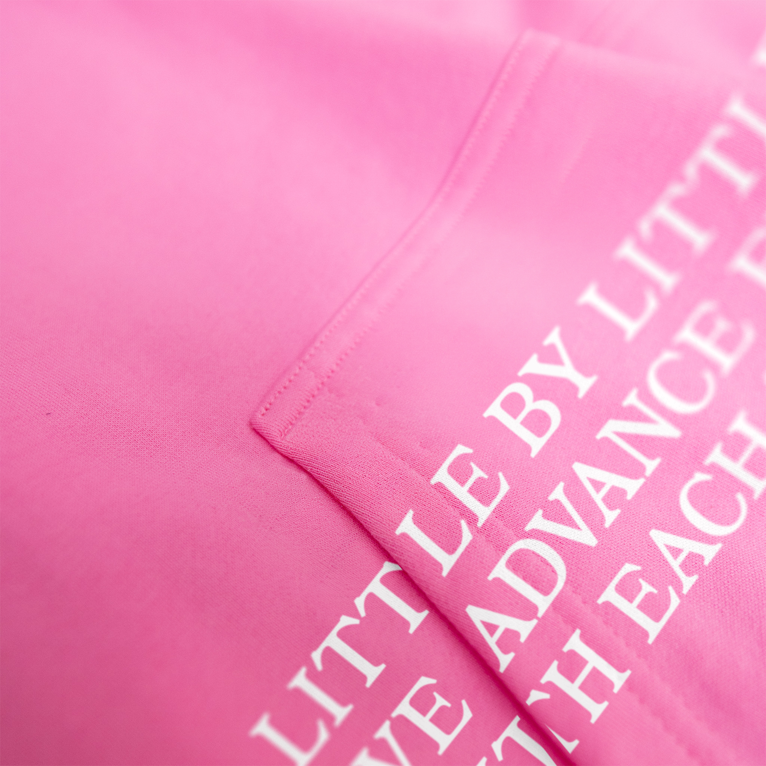 Pink fabric with white text on a pink background